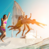 Group of people jumping off of a sailboat into the water | Tint Media on Shutterstock